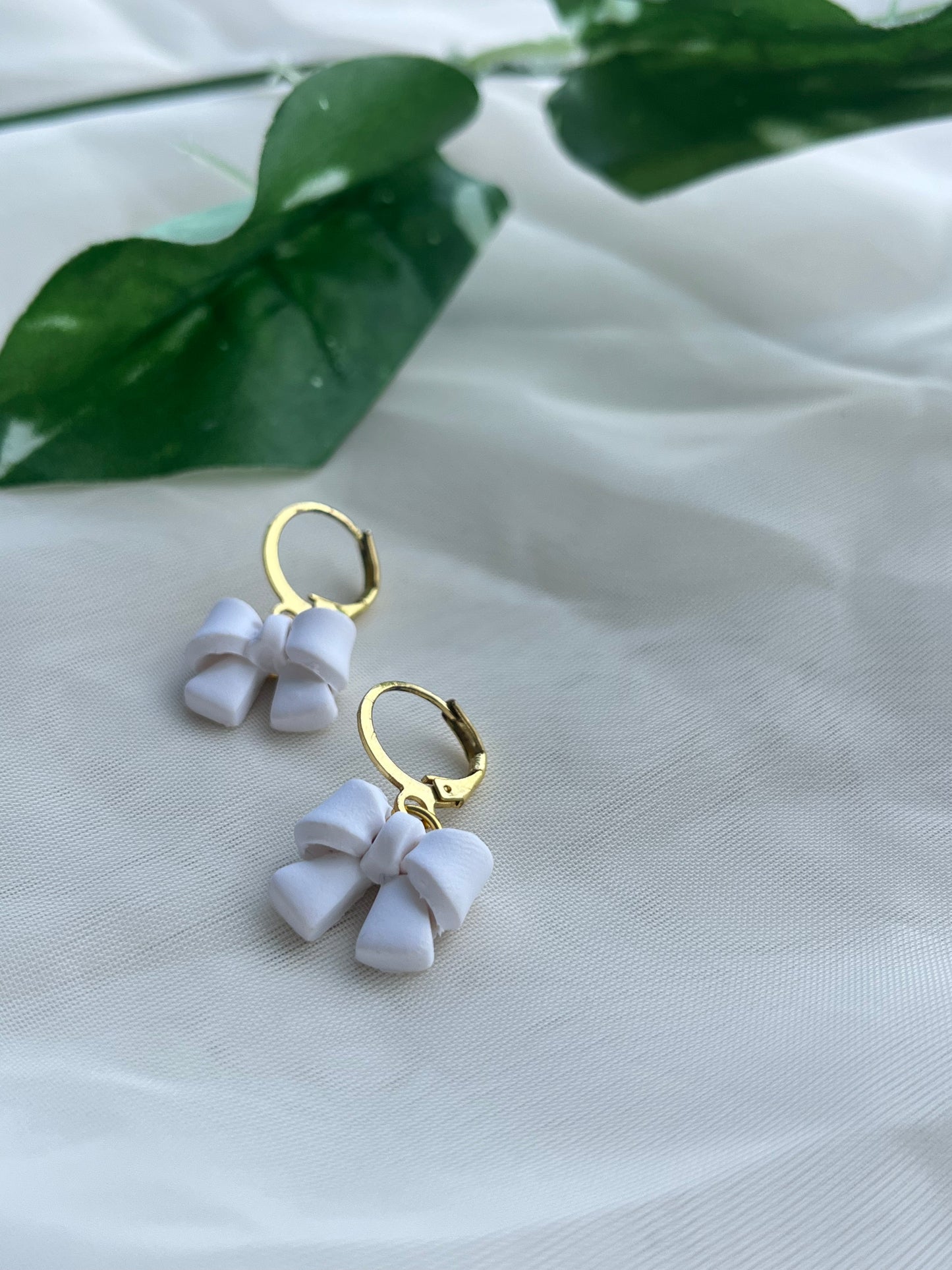 white bow earrings